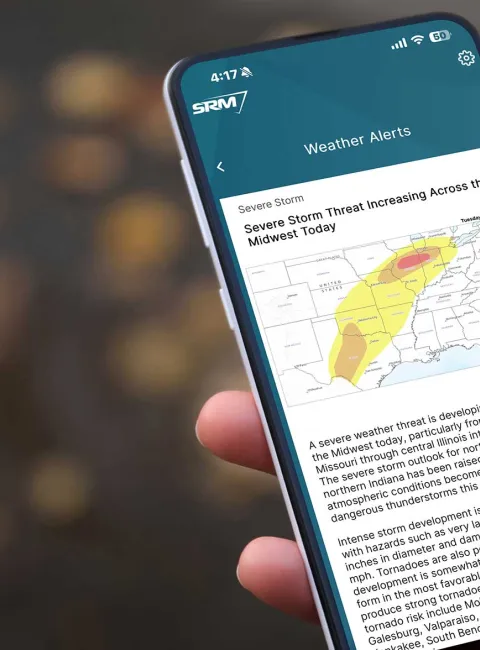 Person holding phone with app visible