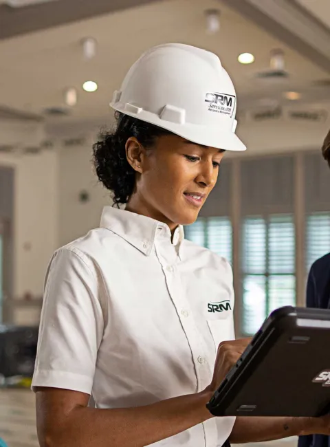 SRM worker speaking with customer in building