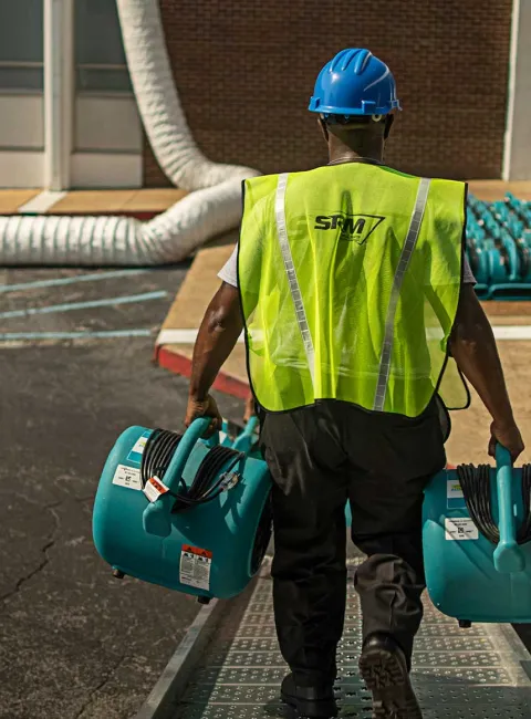 SRM worker carrying dryers