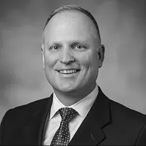 Jim headshot wearing suit and tie