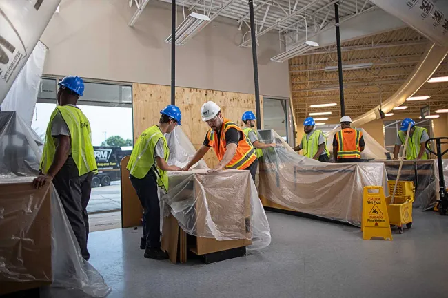 SRM employees covering furniture