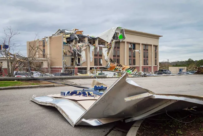 Crushed office building with debris in front