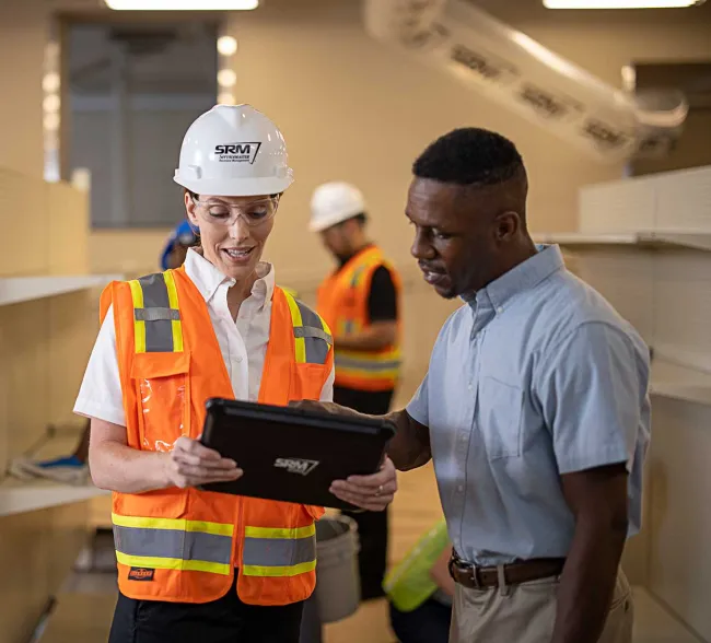 SRM worker in vest talking with customer