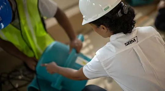SRM employee holding equipment